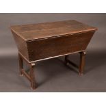An 18th century oak tapered rectangular dough trough, planked top,  joined underframe, 70cm high,