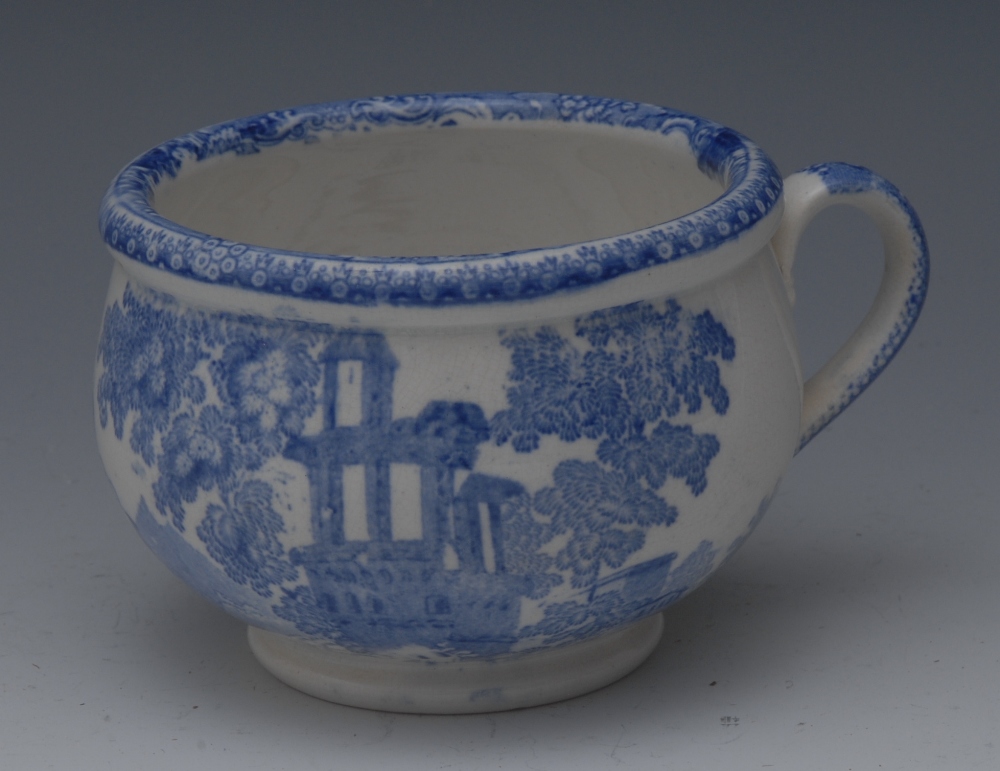 A 19th century blue and white pottery dining room chamber pot, transfer printed with a mosque,