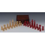 A 19th century turned ivory chess set, natural and stained red, the king 10.