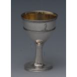 A George III silver pedestal egg cup, reeded rim, centre girdle and base, gilt interior, 7.