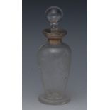 An early 20th century clear glass tapering cylindrical scent bottle, engraved with scrolling leaves,