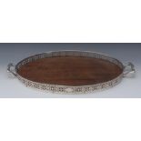 A George V silver mounted oval gallery tray, pierced border, carrying handles to sides, 59cm wide,