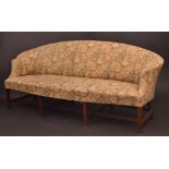 A George III mahogany sofa, arched back, bowed arms, stuffed-over seat, upholstered,