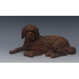 A Black Forest carved and stained wood inkstand,  modelled as a recumbent hound,