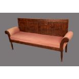 A George III oak settle, rectangular back with four panels, squab cushion, upholstered scroll ends,