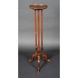 An Edwardian mahogany tripod statuary pedestal dished circular top, turned columns, cabriole legs,