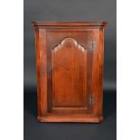 A George III oak splay fronted wall hanging corner cabinet, stepped cornice,