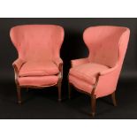 A pair of Adam Revival wingback armchairs, stuffed-over upholstery, squab cushions,