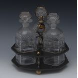 A late Regency octagonal black lacquered  three bottle decanter stand,