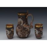 A Doulton Lambeth stoneware 'Dragon' ewer and two beakers, designed by Bessie Newbery,