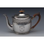 A George III provincial silver oval teapot, domed flush-hinged cover, scroll capped handle,