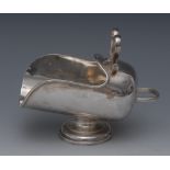 A George V silver novelty sugar scuttle, scroll handle, stepped circular foot, 14.