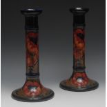 A pair of Moorcroft Poppy pattern candlesticks,