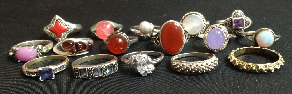 A circular carnelian cabochon and silver dress ring;  another,