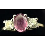 A pink sapphire and diamond three stone ring,