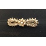 A Victorian seed pearl and ribbon bow brooch, central flower head set with seven seed pearls,