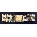 A 1911 sovereign panel gate bracelet, eight row gate link bangle, padlock clasp, 27.