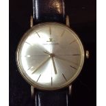 A Jaeger LeCoultre gentleman's gold cased wrist watch, silver round dial, baton markers,