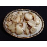 A 19th century Dieppe ivory brooch, the carved oval panel a floral study,
