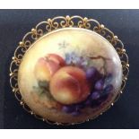 A Royal Worcester porcelain panel brooch, painted by R Seabright, with grapes, peaches and leaves,