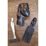 Tribal Art - an African carved head; a comb;