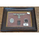 A framed collection of German Nazi Third Reich badges