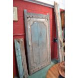 A large painted oak door and frame