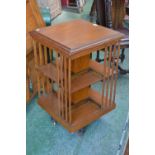 An Edwardian oak rotating library bookcase c.