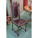 A Victorian Jacobean revival oak hall chair, the back splat carved with oak leaves, spire finials,