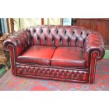 A red leather Chesterfield sofa