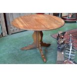 An Ercol style oak circular pedestal centre/dining table