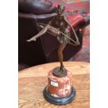 An Art Deco style bronze- Girl with Hula Hoop on rouge marble base