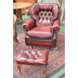 A red leather button back rocking armchair,