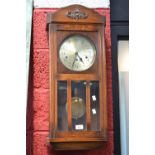 An oak 1940s wall clock