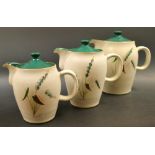 A set of three graduated Denby Greenwheat pattern hot water jugs and covers (3)