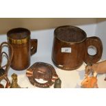 A 19th century oak mug, later brass mount; another,