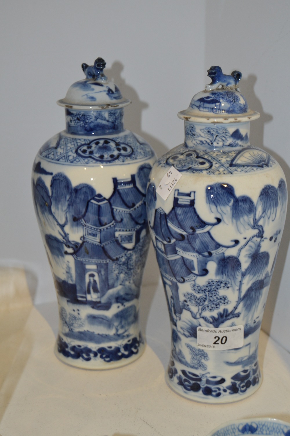 A pair of Chinese inverted baluster vases and covers, decorated in underglaze blue and white,