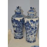 A pair of Chinese inverted baluster vases and covers, decorated in underglaze blue and white,