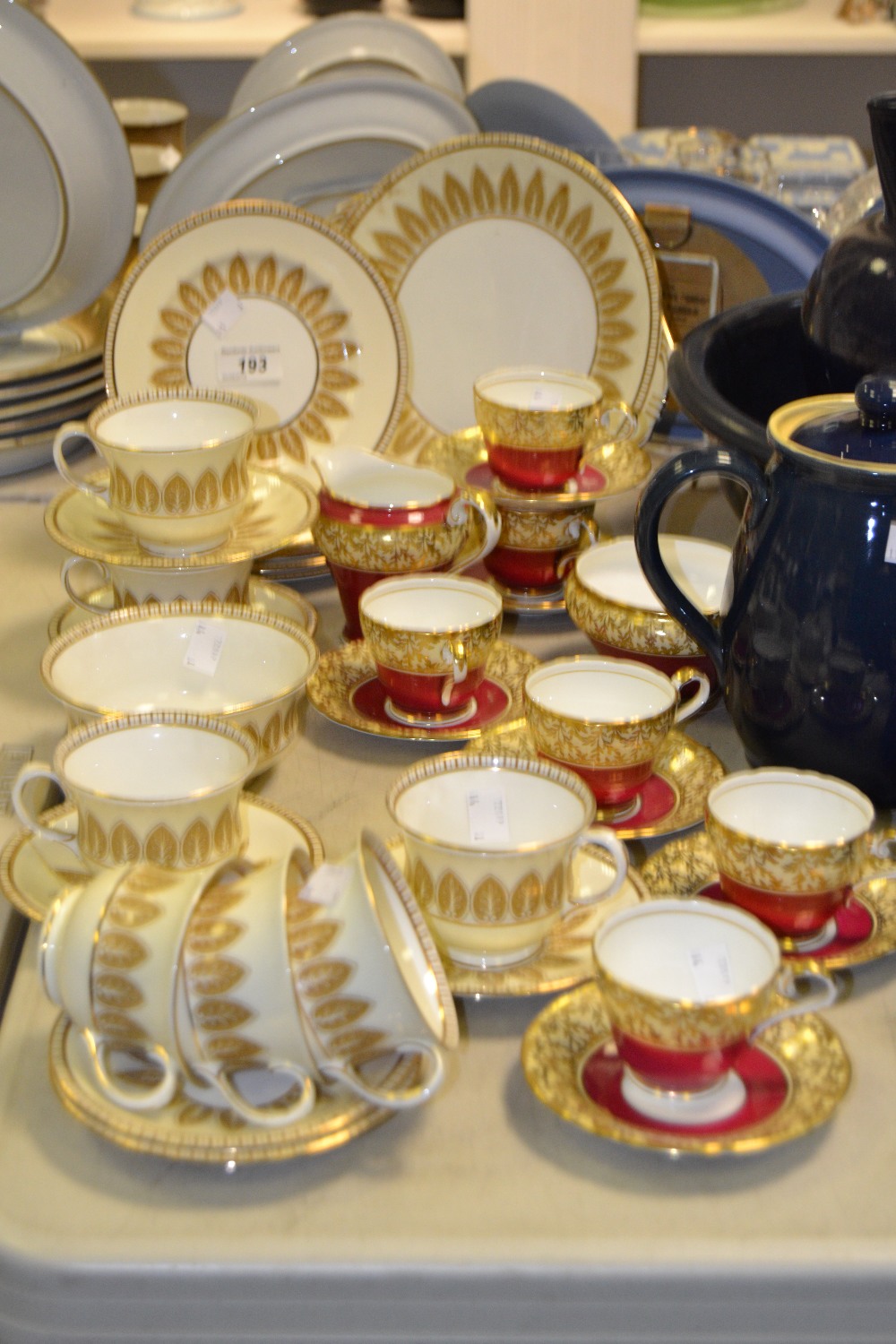 An Aynsley six-setting tea service, printed in sepia with stiff leaf garlands on an ivory ground,