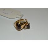 A gentleman's 9ct gold and tiger's eye signet ring; a lady's 9ct gold, garnet and diamond ring, (2),