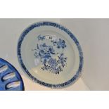 A Chinese circular plate, decorated in underglaze blue with foliage and flowers,