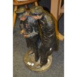 An early 20th century plaster figural group, The Whispering Pensioners,