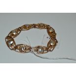 A 9ct gold wirework bracelet,set with mother-of-pearl stones, 11.