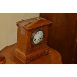 A late Victorian oak mantel clock,