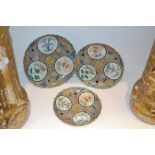 A set of three graduated Japanese shaped circular plates, painted with roundels,