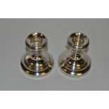 A pair of silver dressing table candlesticks, 7cm high,