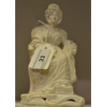 A Derby biscuit figure, of an elderly lady seated on a chair, one foot on a stool, scroll base,