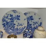 A pair of Japanese blue and white chargers, decorated in underglaze blue with song bird and peonies,