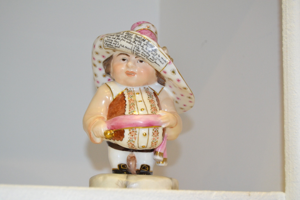 A Royal Crown Derby Mansion House dwarf, standing, wearing a broad brimmed hat, brown fancy shirt,