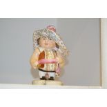 A Royal Crown Derby Mansion House dwarf, standing, wearing a broad brimmed hat, brown fancy shirt,